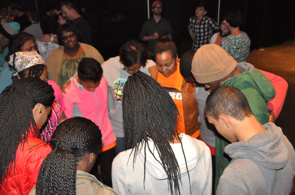 Youth praying in circle during altar call