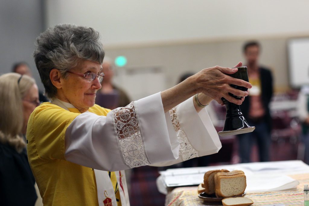 Bishop Peggy Johnson serving mid-day Communion