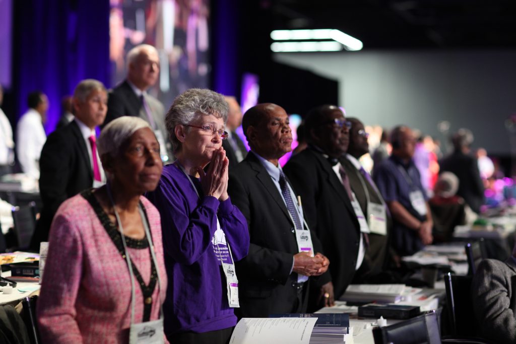 Bishop Peggy Johnson and her episcopal colleagues stand in witness to the challenges ahead during worship at General Conference 2016 in Portland, Ore., in May. UMNS photo