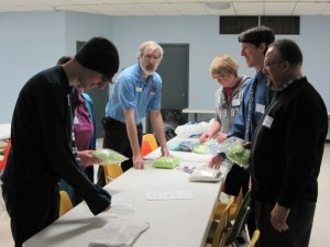 Youth and clergy pack UMCOR Health Kits with Conference Disaster Coordinator Greg Ellis and DS Dr. Irving Cotto.