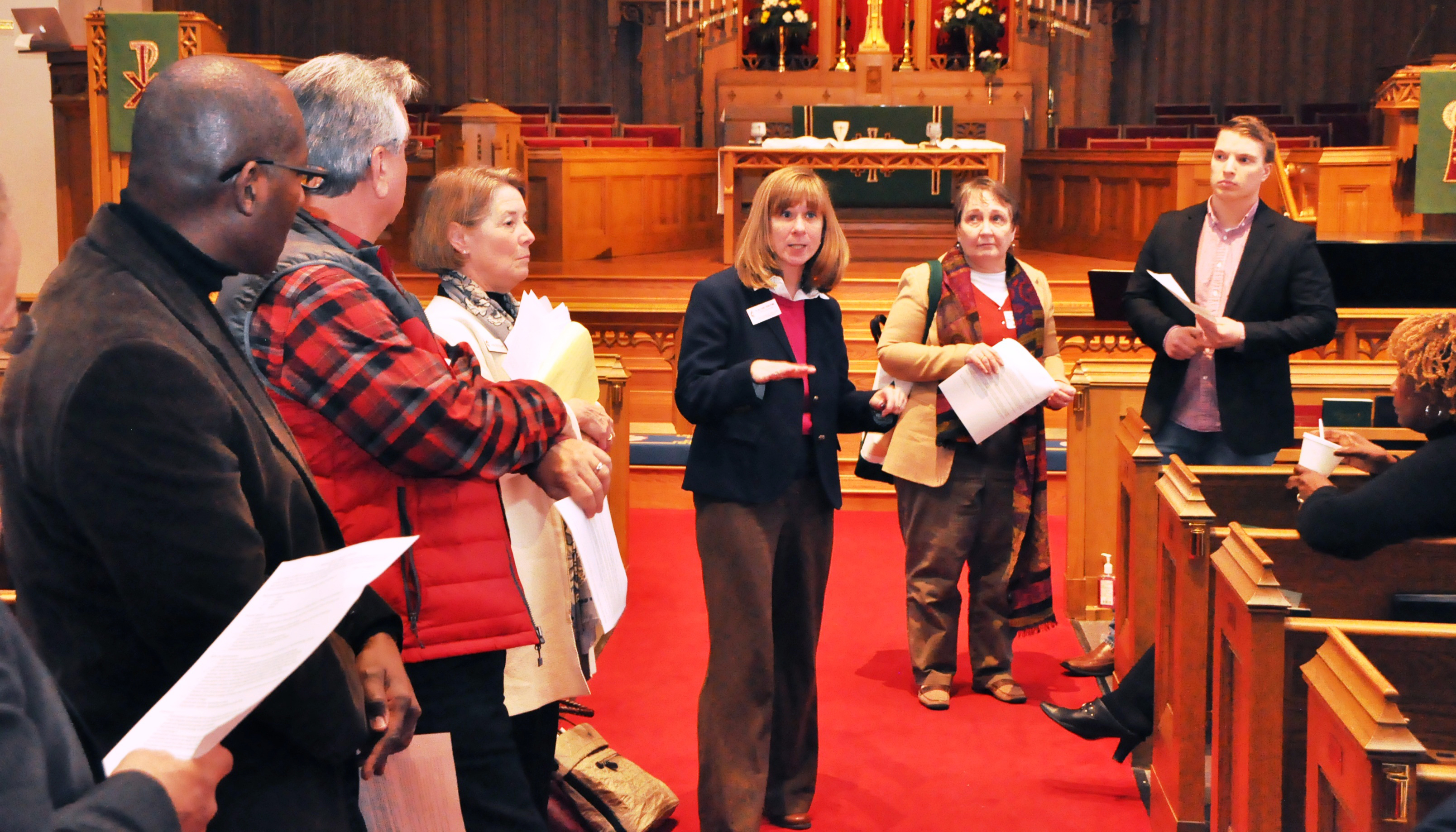 Eastern PA Conference delegates to the 2016 General and Jurisdictional conferences huddle in the sanctuary of First UMC Lancaster at a break during the joint briefing there Jan. 30 for delegates from five annual conferences.