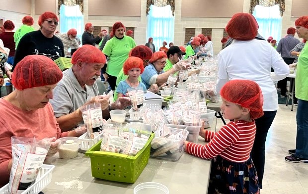 Featured image for “Church packs 10,000+ meals to donate in 1 special day”